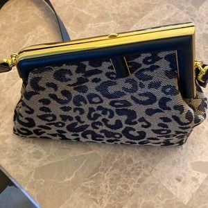 Oversized metal clasp bound with tone on tone